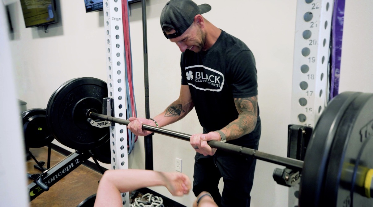 Adults training together in a small-group setting at Black Clover Fitness